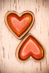 Fototapeta premium Two wooden hearts on rustic wood background. Valentines days con