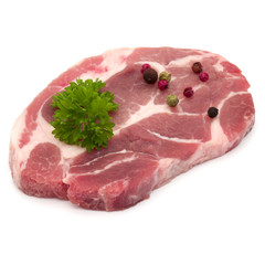 Raw pork neck chop meat with parsley herb leaves and peppercorn