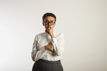 Scared and tired looking teacher in deep thought against white wall background