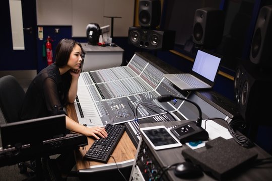 Female student using sound mixer