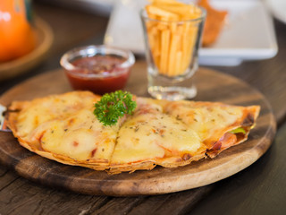 Pizza in wooden tray, On the table.