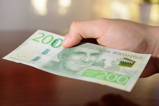 man holding new swedish 200 bank notes. NOTE: the new model.
