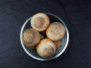 Straw mushroom in a glass bowl with dark background
