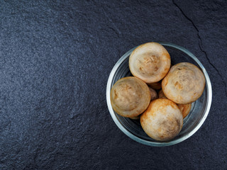 Straw mushroom in a glass bowl with dark background