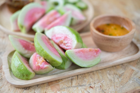 Ripe guava fruit cut with sweet sauce. Selective focus