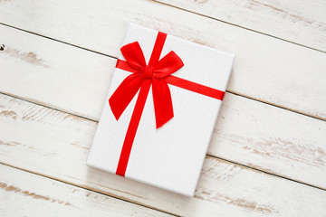 White gift box on white wooden background

