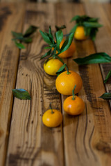 Mandarins fruit with leaves on wooden background