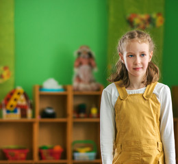 Little girl in kindergarten. Place for your text.