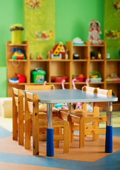 Chairs, table and toys. Interior of kindergarten.