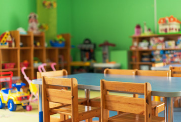 Chairs, table and toys. Interior of kindergarten.