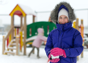 Portrait of happy little girl in winter time.