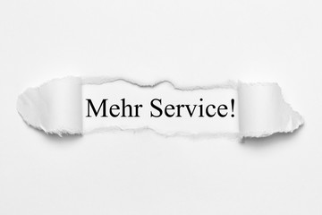 Fototapeta premium Mehr Service! auf weißen gerissenen Papier