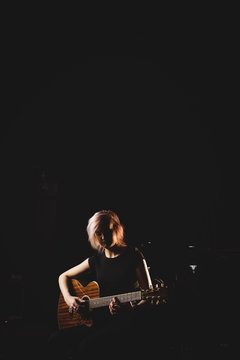 Female student playing guitar