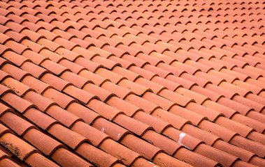 Red roof tiles or shingles on house as background image.