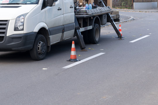 warning orange and white cones pretecting men at work