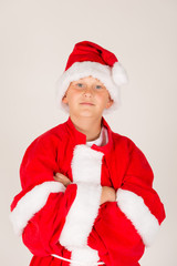 kleiner Junge mit viel zu großem Weihnachtsmann Kostüm hat Spaß (mit Mütze)