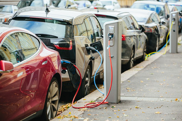 Vehicle with an electric motor. Electric vehicle charging. Eco car. - obrazy, fototapety, plakaty