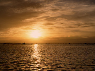Fototapeta na wymiar Beautiful sunset landscape orange golden sky above sea.