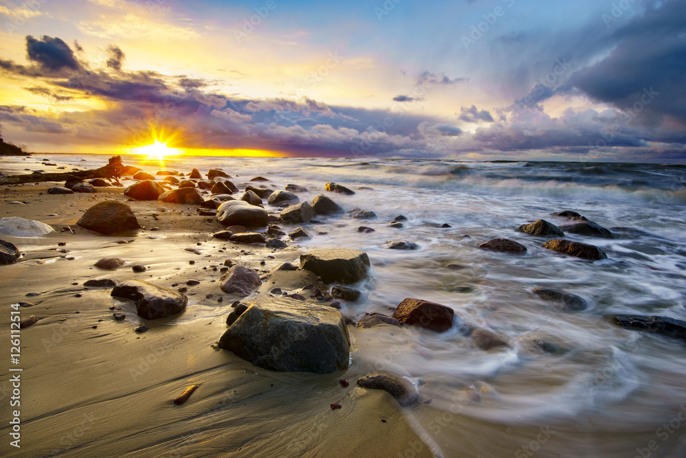 Wall mural sunset over the stormy sea
