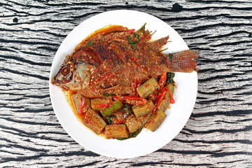 Deep-fried tilapia fish topped Spicy fried eggplant.