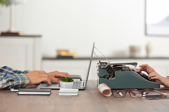 Old typewriter and laptop, concept of technology progress