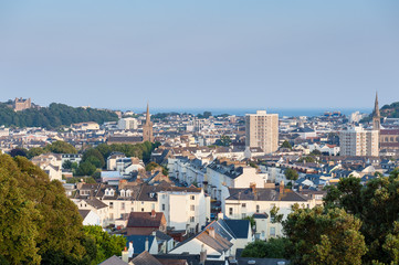 View over Saint Helier, capital of Jersey, Channel Islands, UK on summer evening around sunset.