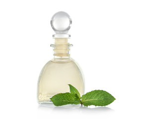 Essential oil with mint on white background