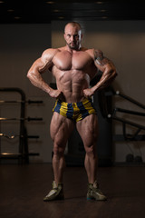 Fototapeta na wymiar Muscular Man Flexing Muscles