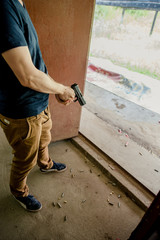 A man prepares to shoot a handgun