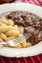 Potato dumplings with a sauce of beef.