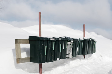 Row of mail boxes on snow covered field