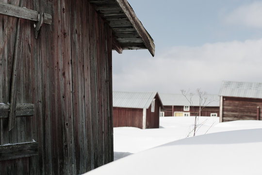 Houses on snow covered field against sky