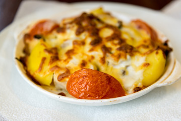 Potatoes with tomatoes baked with cheese