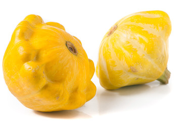 two yellow pattypan squash isolated on white background