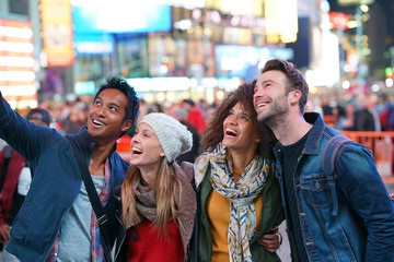 Group of friends having fun at Times Square, NYC