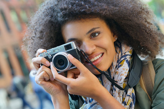 Trendy girl in New York City taking pictures with camera