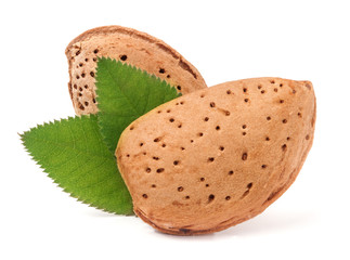 almonds in their skins with leaf isolated on white background