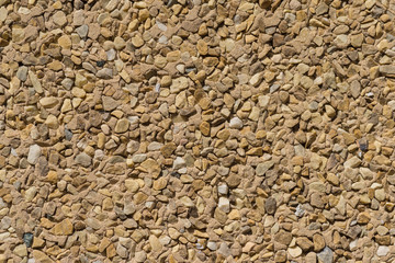 wallcovering with small pieces of different stones texture stone wall