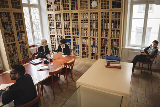 High angle view of lawyers working in board room at library