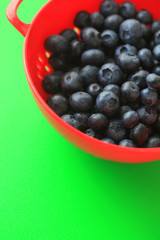 Fresh blueberries with green background