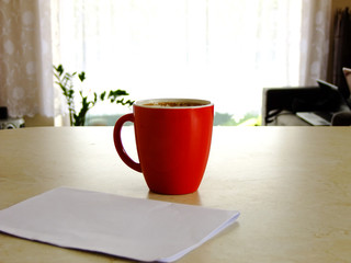 A Cup of Coffee and a blank Paper on the Table at Home
