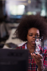 young woman at office looking at sand  clock