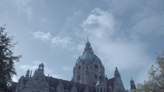 New Town Hall in Hanover, Germany. Tilt from the sky to front of the building in 4K and S-Log3. Long shot. Autumn. Neues Rathaus Hannover.