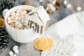 Big mug of hot cocoa with marshmallow decorated with mini ginger