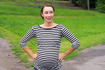 Fototapeta premium Pregnant woman with hands on waist
