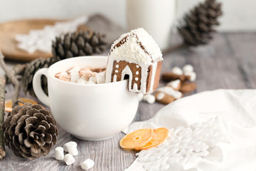 Big mug of hot cocoa with marshmallow decorated with mini ginger - obrazy, fototapety, plakaty