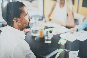 Black african project manager during business meeting in a modern office.Horizontal,blurred background.