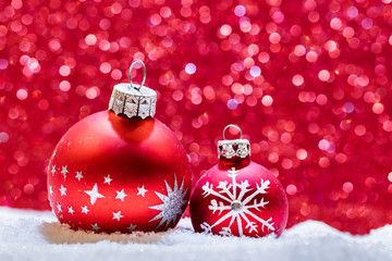 Christmas glass balls in snow. Glitter background