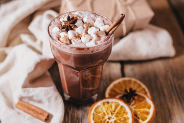 Cocoa or latte or hot chocolate with marshmallow and flavored with cinnamon. On a brown wooden background. Christmas present. Christmas concept. Christmas holiday.