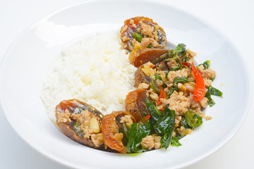 Rice topped with stir-fried preserved egg slice and basil.
